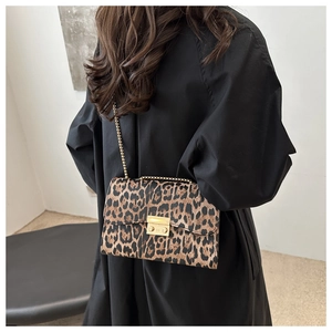 Chic leopard print shoulder bag with gold chain strap and metal lock detail on model