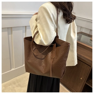 Deep brown large woven tote bag shown on model for a minimalist daily commuter look