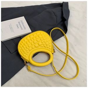 Close-up of bright yellow PU handbag featuring embossed bubble texture and ring handle
