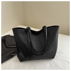 Close-up of the black woven leather texture and spacious design of this oversized tote bag
