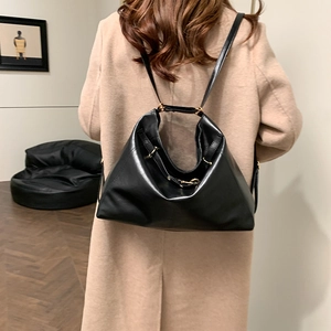Minimalist black leather convertible tote bag with high gloss finish and golden buckles