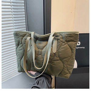 Dettaglio della borsa tote trapuntata verde militare con cuciture a onda e spalline sottili