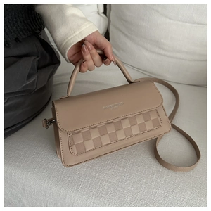 Detail of khaki textured crossbody bag with silver fashion trend lettering on the flap