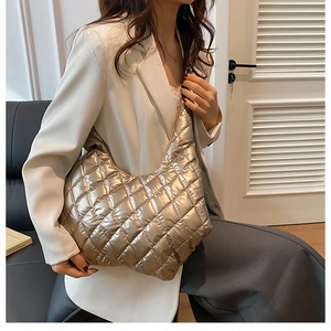 Detail of metallic quilted hobo shoulder bag with glossy champagne finish for women