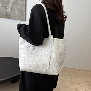 Minimalist white woven tote bag with spacious capacity and slender shoulder straps
