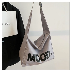 Detail of grey canvas tote bag with black MOOD print and sturdy wide shoulder strap