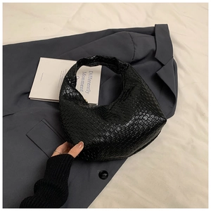 Detailed view of black woven leather Hobo bag with intricate checkerboard texture