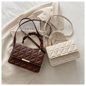 Quilted flap handbag detail featuring ruched handles and gold lock hardware in two colors