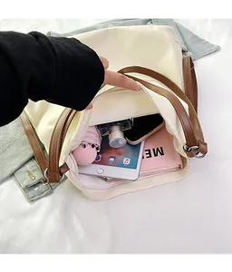 Interior view showing the large capacity of this off-white canvas tote with daily essentials