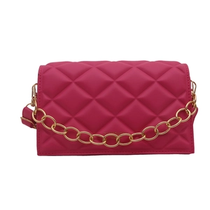Quilted rose red crossbody bag with chunky gold chain detail and textured finish