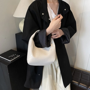 Minimalist white woven hobo shoulder bag with a textured geometric pattern