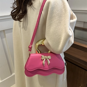 Pink bow handbag with scalloped bottom and gold handle for women crossbody style