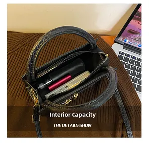 Internal capacity of black crocodile embossed tote bag with power bank and spray bottle