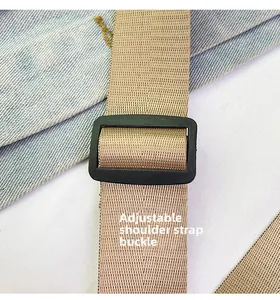 Close-up of adjustable light khaki nylon shoulder strap with durable black plastic buckle
