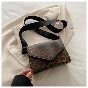 Detail of leopard print crossbody bag with envelope flap and wide nylon shoulder strap