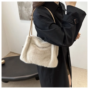 Detailed close-up of beige faux fur tote bag with slim leather straps and soft texture