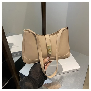Close-up of matte PU leather shoulder bag with decorative gold metal turn-lock buckle