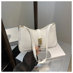 Close-up of white textured leather baguette bag featuring a gold square twist lock