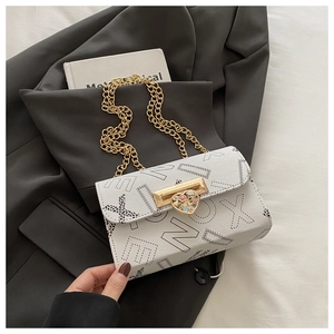 Close-up of white crossbody bag with letter print and heart-shaped enamel rotary lock