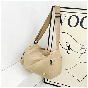 Detail of khaki large capacity nylon crossbody bag with golden metal logo and wide strap