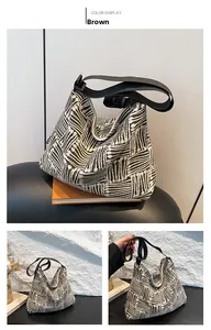 Close-up of brown geometric pattern canvas tote bag with adjustable black strap