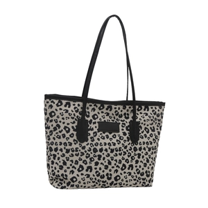 Chic leopard print canvas tote bag with black shoulder straps and center leather patch