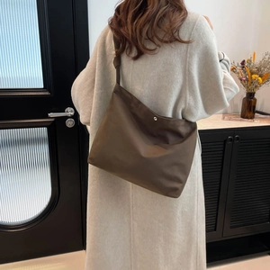 Minimalist large brown suede tote bag for women showing a casual crossbody look