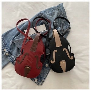 Creative violin-shaped leather crossbody bags in red and black with detailed stitching