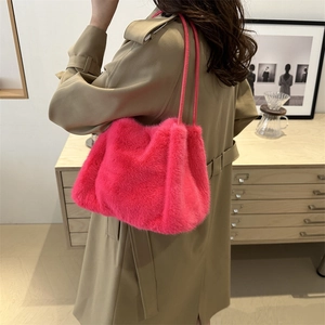 Furry faux fur shoulder bag in vibrant rose red with leather straps for winter style