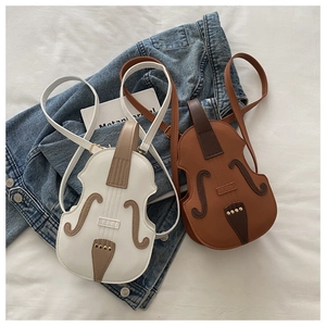 Detail view of violin-shaped PU leather crossbody bags with fine stitching and metal rivets