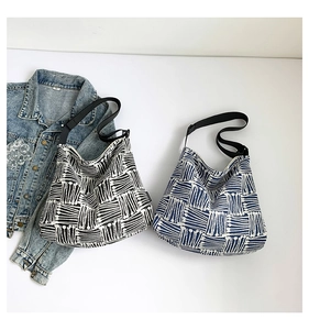 Macro shot of large canvas tote bag with abstract geometric patterns and wide strap