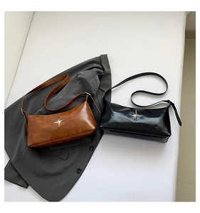 Detail of vintage glossy leather shoulder bags with star-shaped silver metal hardware