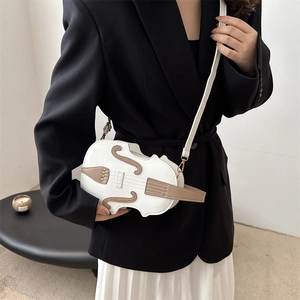 Unique violin shaped crossbody bag in white with brown leather accents and metal studs