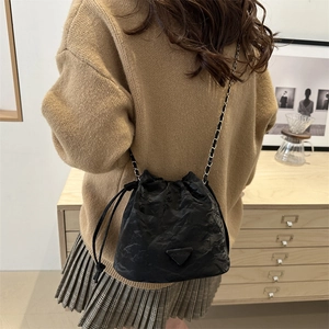 Chic black drawstring bucket bag with textured leather and chain strap for women