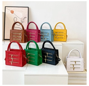 Detailed display of crocodile embossed tote bags in eight vibrant colors with gold zippers
