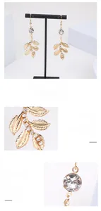 Vue macro détaillée de boucles d'oreilles feuille dorée ornées de strass en cristal