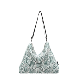 Green and white striped canvas tote bag with black straps and fashion label detail