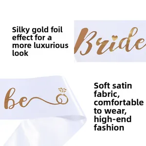 Detail of white bridal satin sash with golden foil Bride text and heart patterns