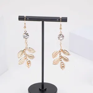 Élégantes boucles d'oreilles feuilles dorées avec cristaux blancs pour mariée et fête
