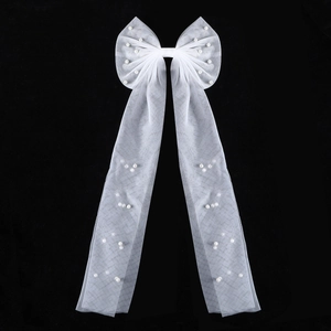Elegant white tulle bow hair accessory with pearls and long flowing ribbons for brides