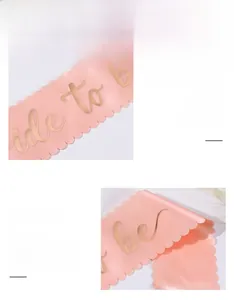 Detail of pink satin Bride to be sash with gold glitter lettering and scalloped edges