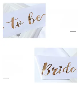 Detail of white satin sash with elegant gold foil Bride To Be lettering for bridal shower