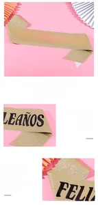 Detailed macro shot of gold glitter birthday sash with black Feliz Cumpleaños text