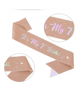 Detail of rose gold glitter sash with holographic It's My 7th Birthday text and crown icon