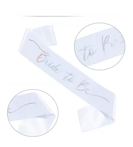 Detail of white satin Bride to Be sash with holographic laser lettering for bridal shower