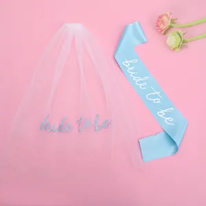 Bridal party set with white bride to be veil and blue satin sash on pink background