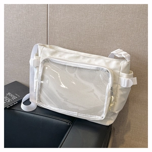 Detail of white nylon messenger bag with transparent PVC window and mesh pocket design