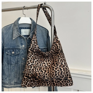 Close-up of leopard print large capacity shoulder bag hanging on metal hanger