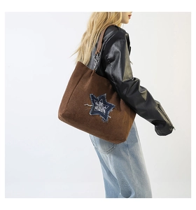 Brown faux suede tote bag featuring a blue denim star patch and metal chain strap