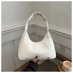 Gros plan d'un sac hobo blanc avec motif tressé en losange et fermeture éclair pratique